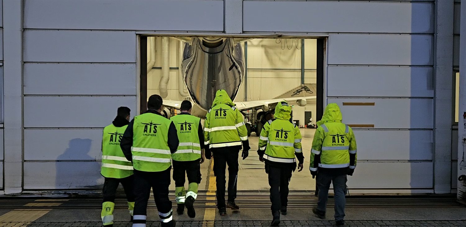 ATS engineering team walking into the hangar towards an aircraft